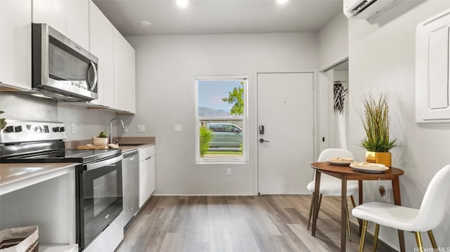 91-3617 Kamolehonua St Unit 208, Ewa Beach, HI 96706 - kitchen featuring stainless steel appliances, light wood-style floors, white cabinets, light countertops, and modern cabinets
