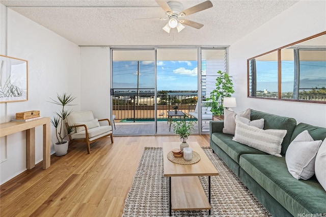 98-099 Uao Pl Unit 506, Aiea, HI 96701 - living room with wood finished floors, ceiling fan, a textured ceiling, and floor to ceiling windows