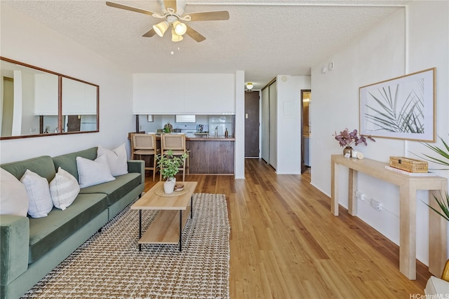 98-099 Uao Pl Unit 506, Aiea, HI 96701 - living area with a ceiling fan, light wood finished floors, and a textured ceiling
