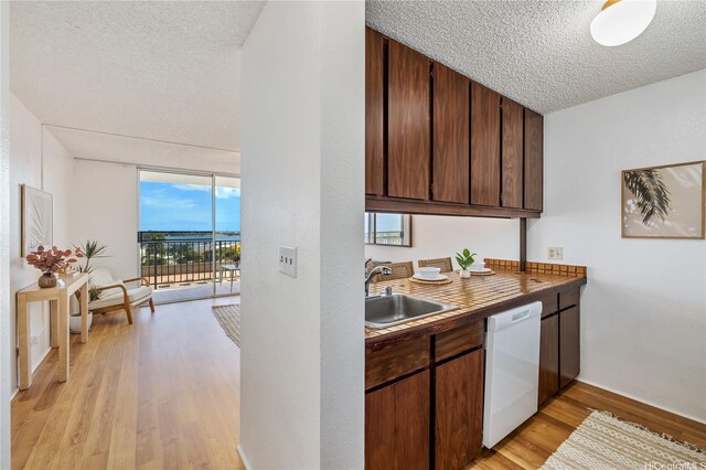 98-099 Uao Pl Unit 506, Aiea, HI 96701 - kitchen with dishwasher, a textured ceiling, light wood finished floors, floor to ceiling windows, and dark brown cabinets