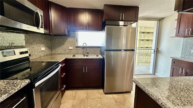 1121 Wilder Ave Unit 900B, Honolulu, HI 96822 - kitchen with stainless steel appliances, decorative backsplash, a textured ceiling, light stone counters, and light tile patterned flooring