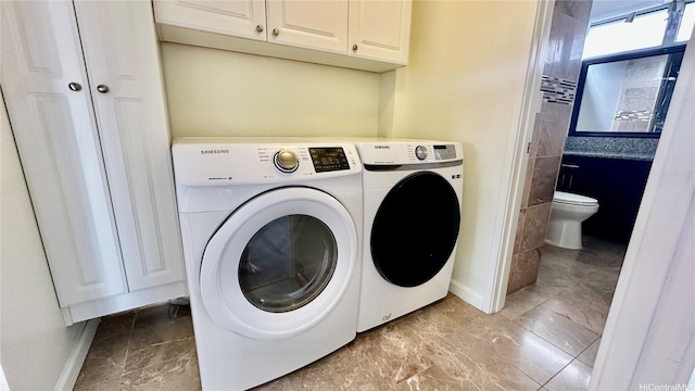 1121 Wilder Ave Unit 900B, Honolulu, HI 96822 - washroom featuring washer and clothes dryer and cabinet space
