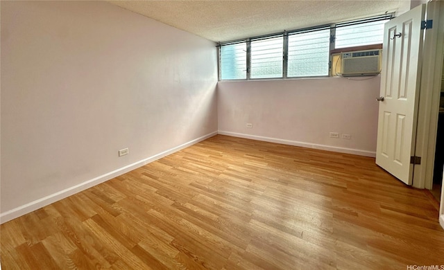 1121 Wilder Ave Unit 900B, Honolulu, HI 96822 - unfurnished room with a textured ceiling, light wood-style flooring, and cooling unit