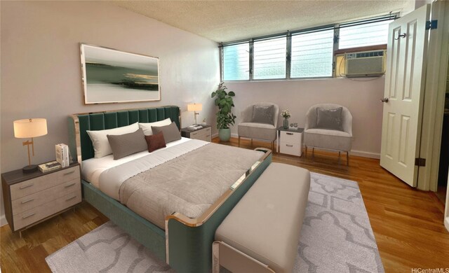 1121 Wilder Ave Unit 900B, Honolulu, HI 96822 - bedroom featuring wood finished floors, a textured ceiling, multiple windows, and cooling unit