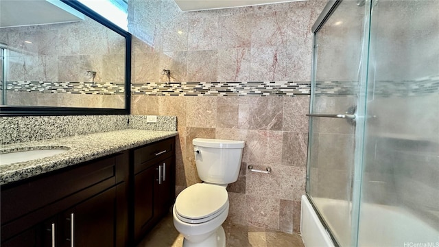 1121 Wilder Ave Unit 900B, Honolulu, HI 96822 - bathroom featuring vanity, combined bath / shower with glass door, and tile walls