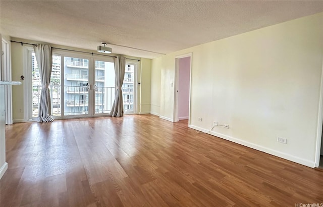 1121 Wilder Ave Unit 900B, Honolulu, HI 96822 - spare room featuring wood finished floors and a textured ceiling