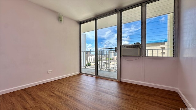 1121 Wilder Ave Unit 900B, Honolulu, HI 96822 - unfurnished room with wood finished floors, cooling unit, and a wall of windows