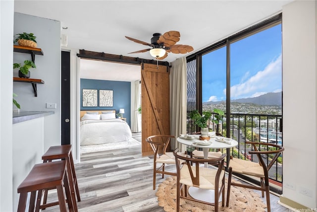 322 Aoloa St Unit 1110, Kailua, HI 96734 - bedroom with a mountain view, a wall of windows, wood finished floors, and a barn door