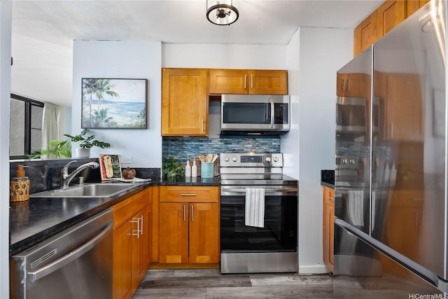 322 Aoloa St Unit 1110, Kailua, HI 96734 - kitchen featuring stainless steel appliances, brown cabinetry, tasteful backsplash, and wood finished floors