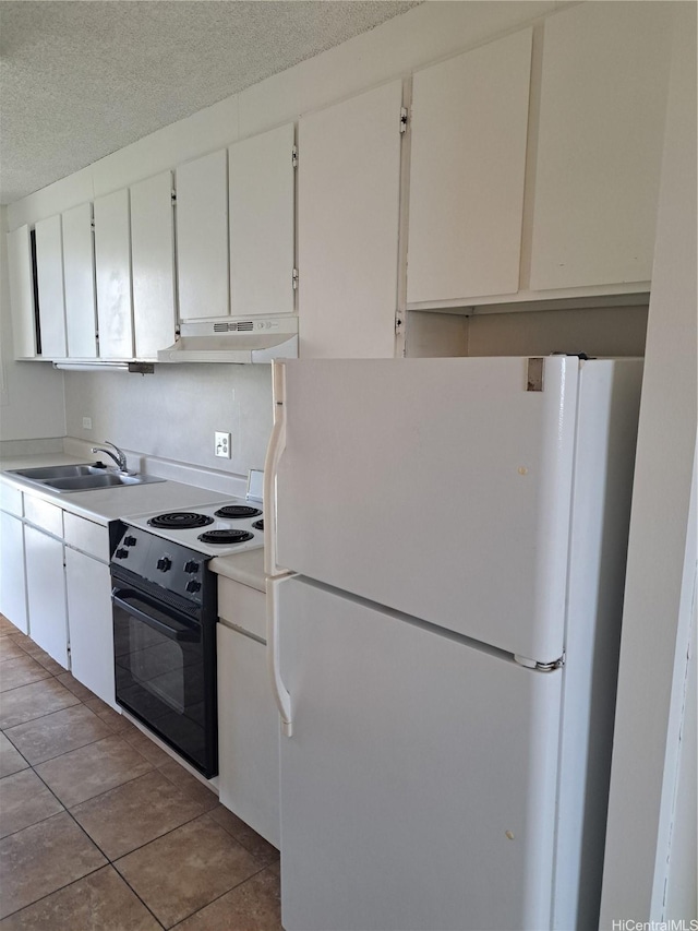 1650 Piikoi St Unit 403, Honolulu, HI 96822 - kitchen featuring freestanding refrigerator, range with electric cooktop, under cabinet range hood, a textured ceiling, and light countertops