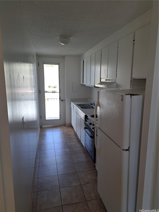 1650 Piikoi St Unit 403, Honolulu, HI 96822 - kitchen with freestanding refrigerator, under cabinet range hood, stove, white cabinets, and a textured ceiling