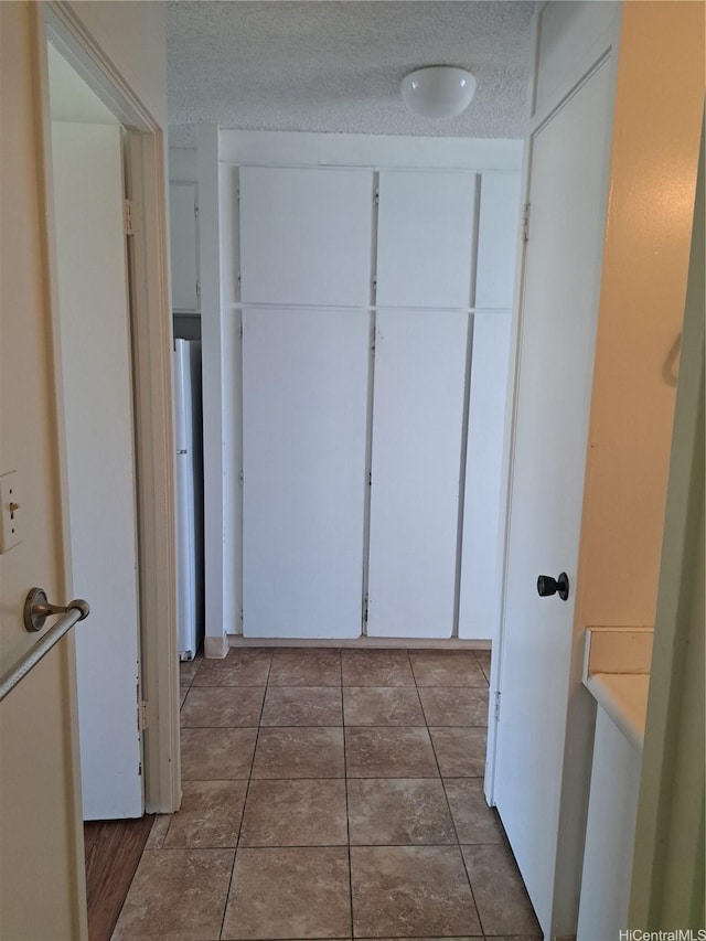 1650 Piikoi St Unit 403, Honolulu, HI 96822 - hallway with a textured ceiling and tile patterned flooring