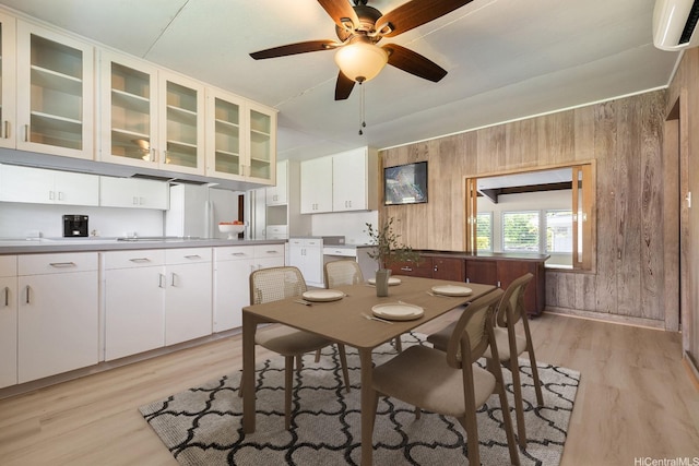 44 Akamu Pl, Honolulu, HI 96817 - dining space featuring a wall mounted air conditioner, light wood finished floors, a ceiling fan, and wooden walls