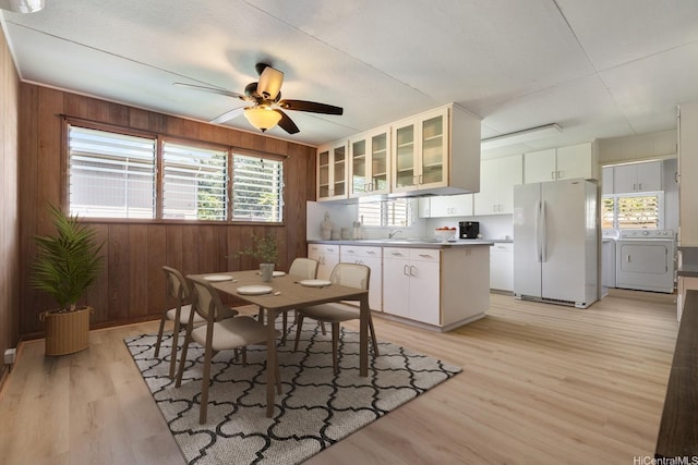 44 Akamu Pl, Honolulu, HI 96817 - dining room with separate washer and dryer, wooden walls, light wood-style floors, and ceiling fan