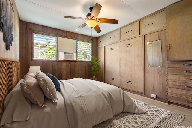 44 Akamu Pl, Honolulu, HI 96817 - bedroom featuring wood walls, light wood-style flooring, a ceiling fan, and cooling unit