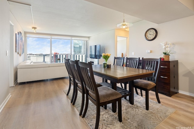 1288 Kapiolani Blvd Unit I-1506, Honolulu, HI 96814 - dining space featuring light wood-style flooring and baseboards