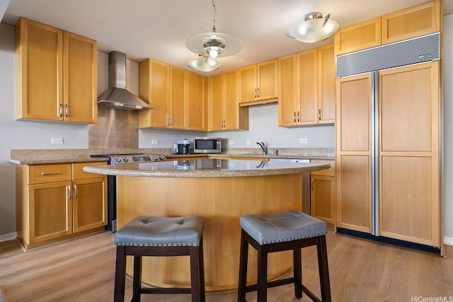 1288 Kapiolani Blvd Unit I-1506, Honolulu, HI 96814 - kitchen with paneled built in fridge, wall chimney range hood, stainless steel microwave, stove, and light wood-type flooring