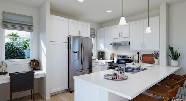 94-1140 Koakolo St Unit 110, Waipahu, HI 96797 - kitchen with appliances with stainless steel finishes, under cabinet range hood, a peninsula, a breakfast bar area, and light countertops