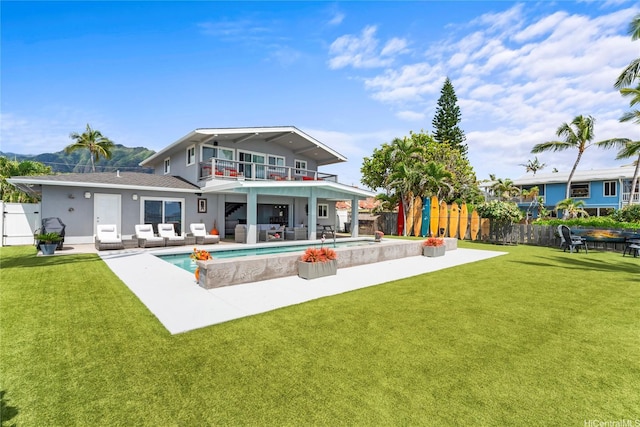 84-663 Upena St, Waianae, HI 96792 - rear view of property featuring a balcony, an outdoor living space, a fenced backyard, a patio area, and stucco siding