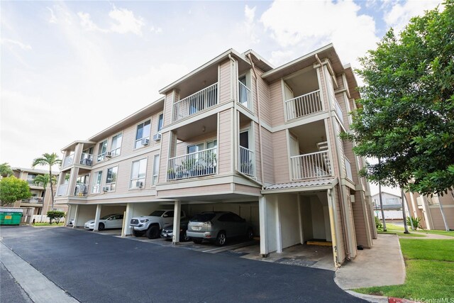 91-1201 Kaneana St Unit 3J, Ewa Beach, HI 96706 - view of apartment building / complex with covered parking