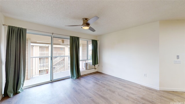 91-1201 Kaneana St Unit 3J, Ewa Beach, HI 96706 - empty room with ceiling fan, wood finished floors, a textured ceiling, and cooling unit