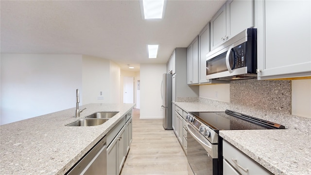 91-1201 Kaneana St Unit 3J, Ewa Beach, HI 96706 - kitchen featuring stainless steel appliances, light wood-type flooring, backsplash, and gray cabinetry