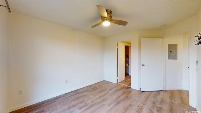 91-1201 Kaneana St Unit 3J, Ewa Beach, HI 96706 - unfurnished bedroom with electric panel, light wood-style flooring, and a ceiling fan