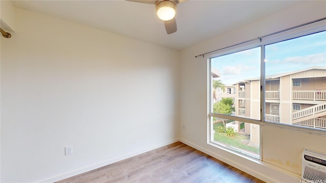 91-1201 Kaneana St Unit 3J, Ewa Beach, HI 96706 - empty room featuring wood finished floors, ceiling fan, and healthy amount of natural light