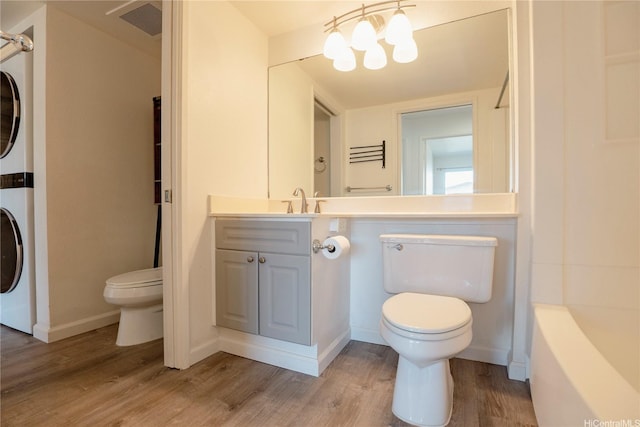 91-1201 Kaneana St Unit 3J, Ewa Beach, HI 96706 - full bathroom featuring stacked washer / drying machine, wood finished floors, vanity, and tub / shower combination