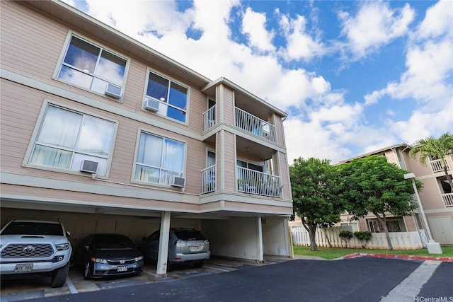 91-1201 Kaneana St Unit 3J, Ewa Beach, HI 96706 - view of building exterior with covered parking and cooling unit