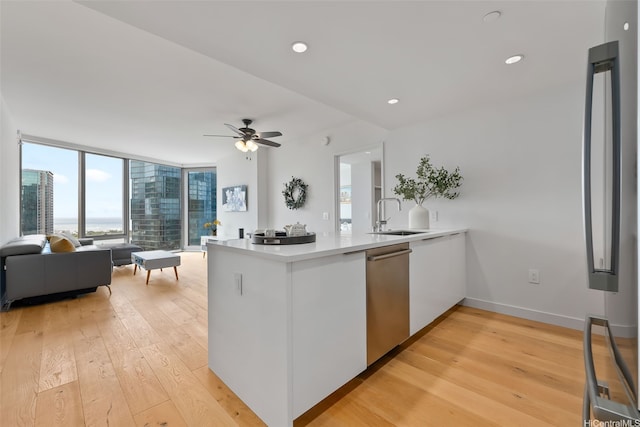 1001 Queen St Unit 2506, Honolulu, HI 96814 - kitchen with stainless steel appliances, a peninsula, light wood-style floors, open floor plan, and floor to ceiling windows