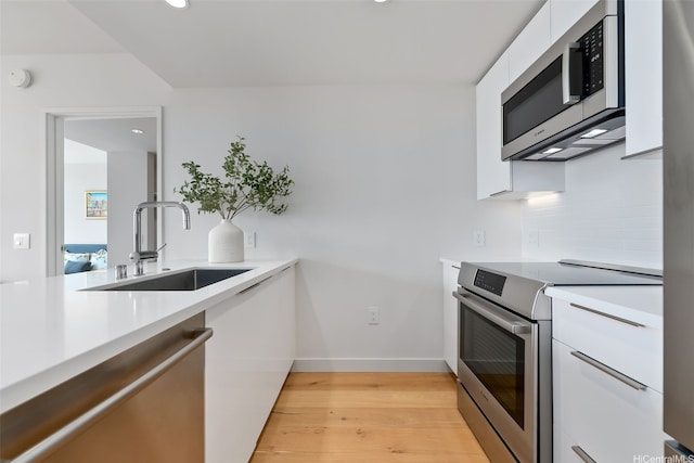 1001 Queen St Unit 2506, Honolulu, HI 96814 - kitchen featuring stainless steel appliances, modern cabinets, white cabinets, light countertops, and recessed lighting