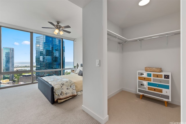 1001 Queen St Unit 2506, Honolulu, HI 96814 - bedroom featuring carpet floors, floor to ceiling windows, a water view, and a ceiling fan