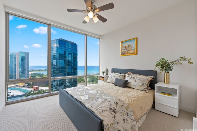 1001 Queen St Unit 2506, Honolulu, HI 96814 - carpeted bedroom with floor to ceiling windows, a water view, and a ceiling fan