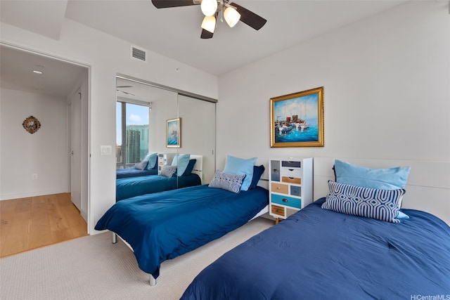 1001 Queen St Unit 2506, Honolulu, HI 96814 - bedroom with wood finished floors, a closet, and a ceiling fan