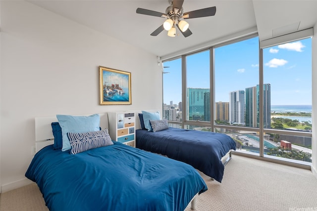1001 Queen St Unit 2506, Honolulu, HI 96814 - carpeted bedroom with multiple windows, a water view, expansive windows, and a ceiling fan