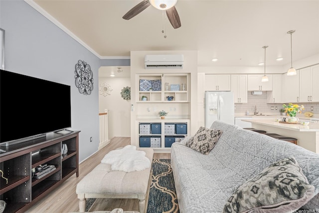 91-3633 Kauluakoko St Unit 412, Ewa Beach, HI 96706 - living room with an AC wall unit, light wood-style floors, ceiling fan, and ornamental molding