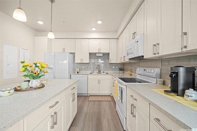 91-3633 Kauluakoko St Unit 412, Ewa Beach, HI 96706 - kitchen featuring white appliances, white cabinets, pendant lighting, decorative backsplash, and light wood-type flooring