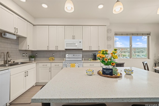 91-3633 Kauluakoko St Unit 412, Ewa Beach, HI 96706 - kitchen with white appliances, white cabinets, a center island, tasteful backsplash, and recessed lighting