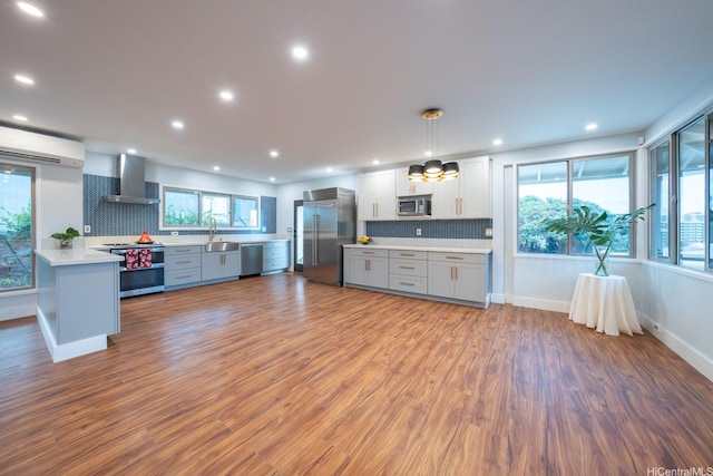 1207 Lilo Pl, Honolulu, HI 96822 - kitchen with stainless steel appliances, wall chimney exhaust hood, light countertops, tasteful backsplash, and wood finished floors