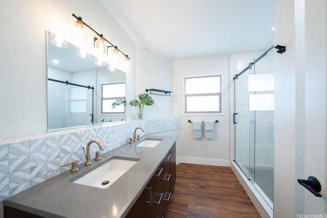 1207 Lilo Pl, Honolulu, HI 96822 - full bath with double vanity, backsplash, a stall shower, and wood finished floors