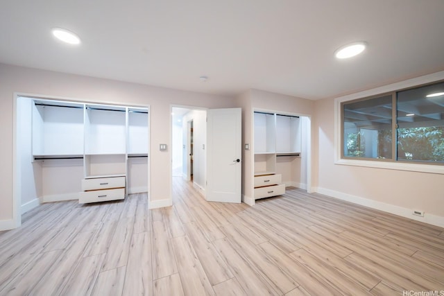 1207 Lilo Pl, Honolulu, HI 96822 - unfurnished bedroom featuring multiple closets and light wood-style flooring
