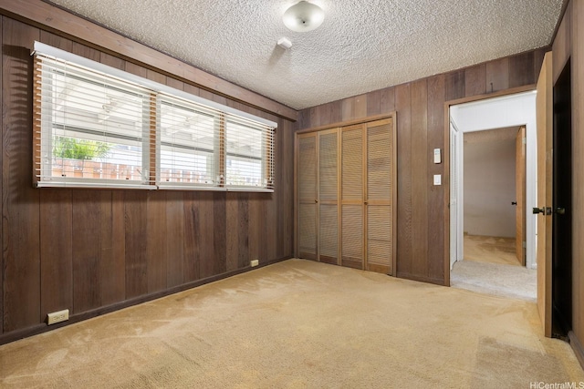 4722 Likini St, Honolulu, HI 96818 - unfurnished bedroom with wooden walls, a closet, carpet flooring, and a textured ceiling