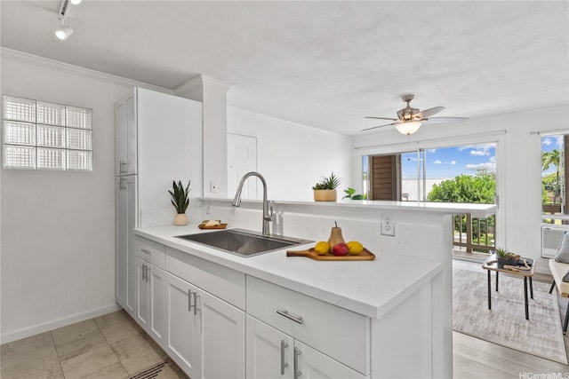 91-1213 Kaneana St Unit 12B, Ewa Beach, HI 96706 - kitchen with a peninsula, light countertops, ceiling fan, white cabinets, and rail lighting