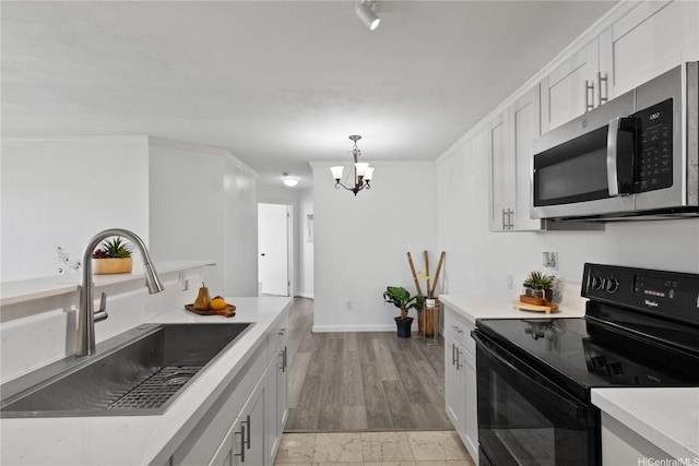 91-1213 Kaneana St Unit 12B, Ewa Beach, HI 96706 - kitchen with stainless steel microwave, electric range, and light countertops