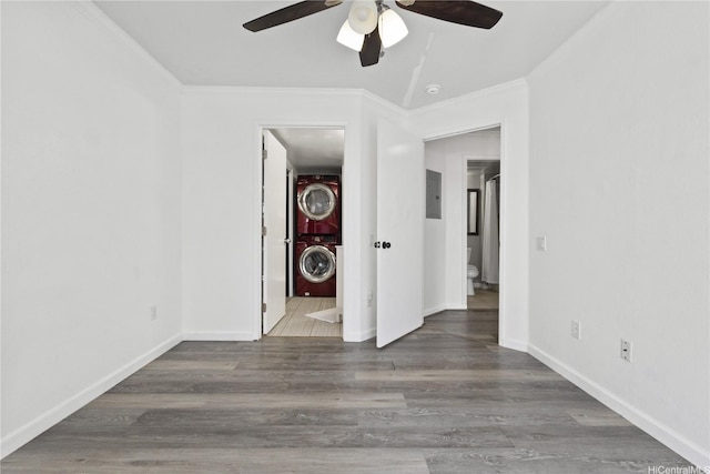 91-1213 Kaneana St Unit 12B, Ewa Beach, HI 96706 - spare room with stacked washer / dryer, electric panel, a ceiling fan, crown molding, and wood finished floors