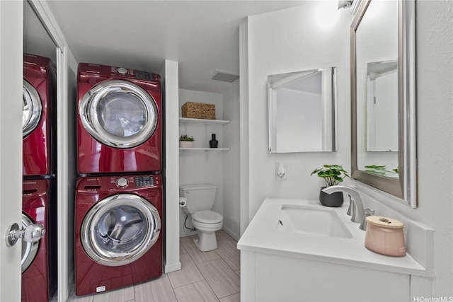 91-1213 Kaneana St Unit 12B, Ewa Beach, HI 96706 - bathroom featuring estacked washer and dryer, vanity, and tile patterned floors