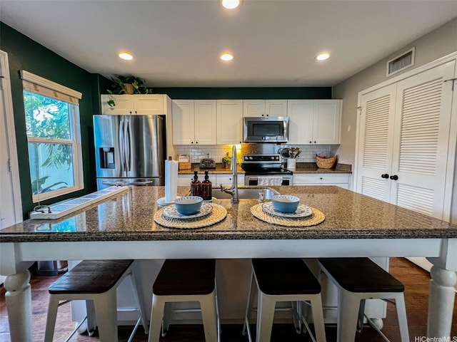 91-1356 Kaileolea Dr, Ewa Beach, HI 96706 - kitchen with appliances with stainless steel finishes, white cabinetry, decorative backsplash, recessed lighting, and dark stone countertops