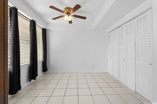 1425 Punahou St Unit 404, Honolulu, HI 96822 - unfurnished bedroom featuring a ceiling fan, a closet, and light tile patterned floors