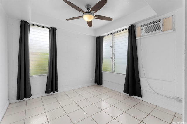 1425 Punahou St Unit 404, Honolulu, HI 96822 - empty room featuring ceiling fan, an AC wall unit, and healthy amount of natural light